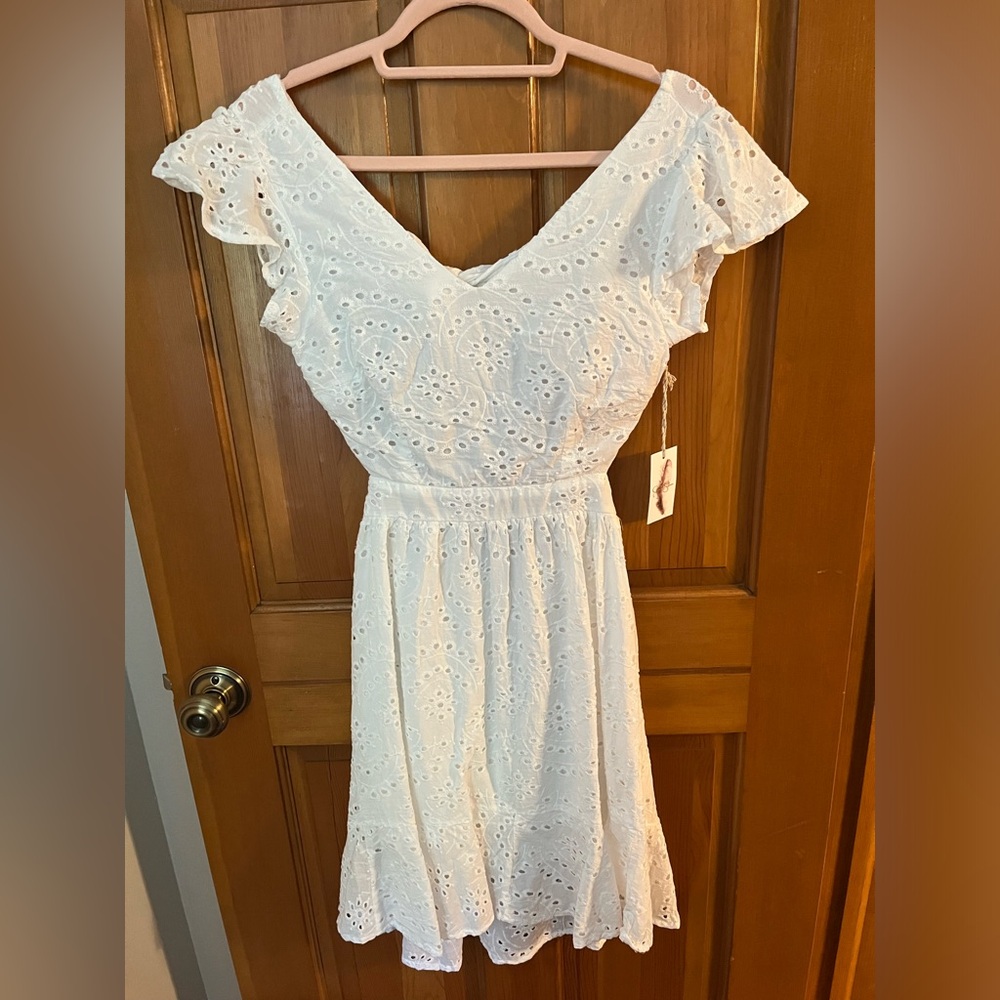 Mini tie-back eyelet dress. Never worn with tags.